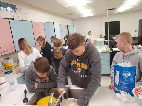 Middle school leadership class prepares breakfast for teachers