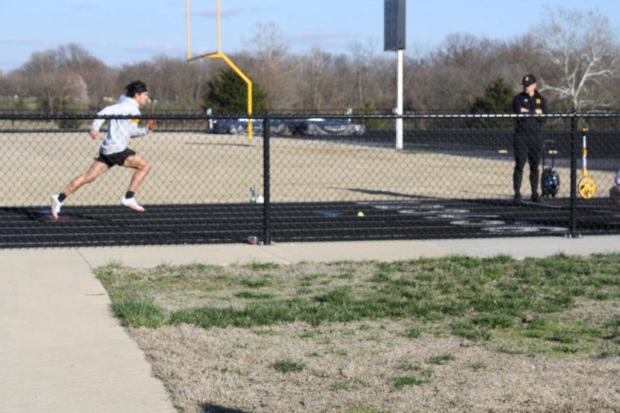 Nick+Meza%2C+sophomore%2C+practices+his+baton+handoffs+and+sprints+as+Nathan+Moser+watches+his+form.