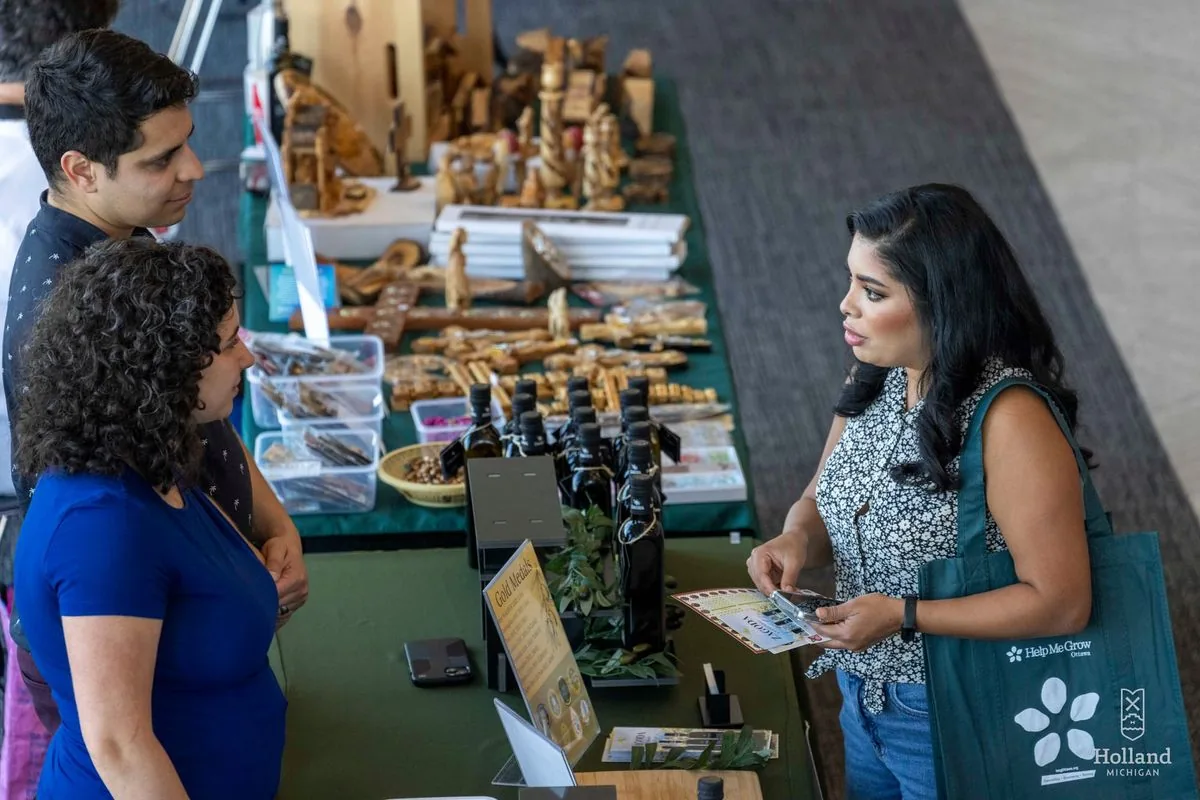 People browse cultural food and marketplace booths at the International Festival of Holland
