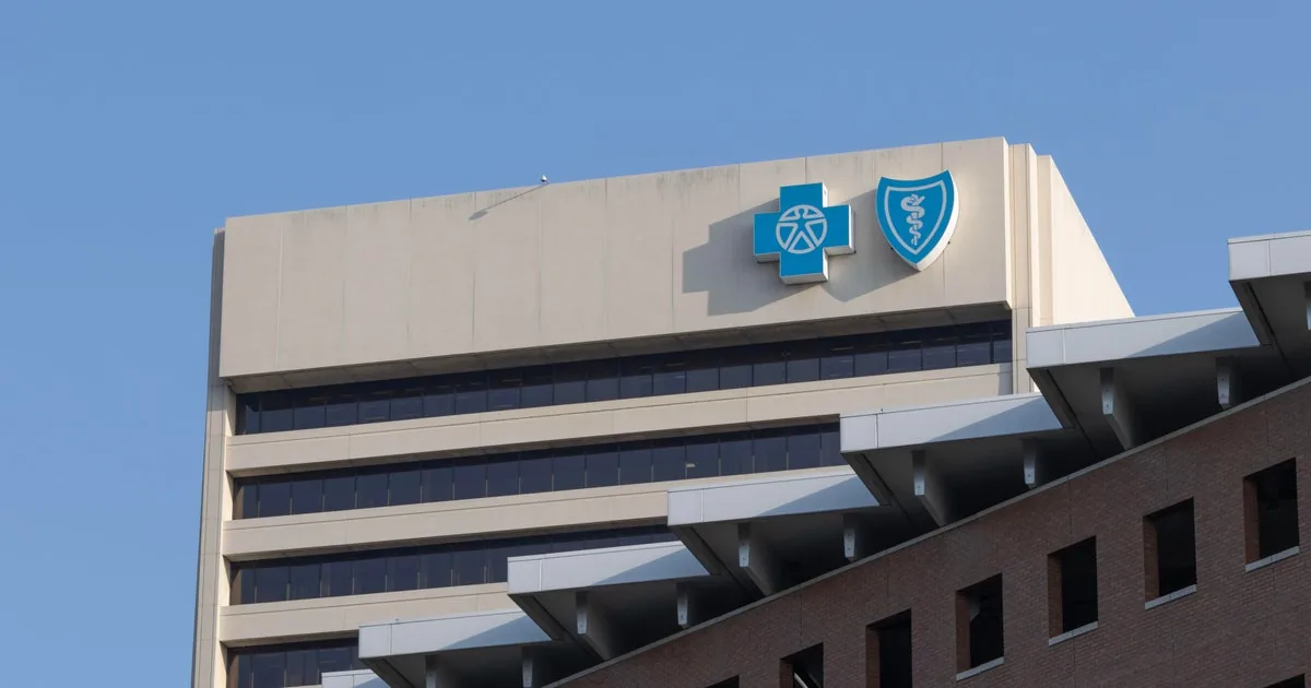 Blue Cross Blue Shield of Michigan office signage with a legal complaint over monopoly claims